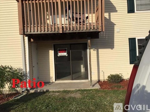 A patio area is visible in front of a house.