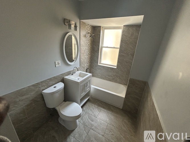 A bathroom with a toilet, sink, and bathtub.