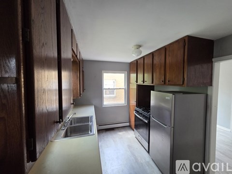 A kitchen with wooden cabinets and stainless steel appliances.