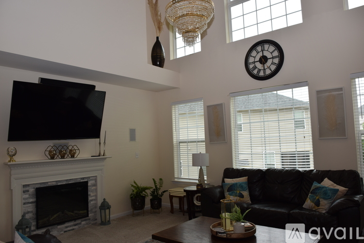 A bedroom with a bed, dresser, and television.