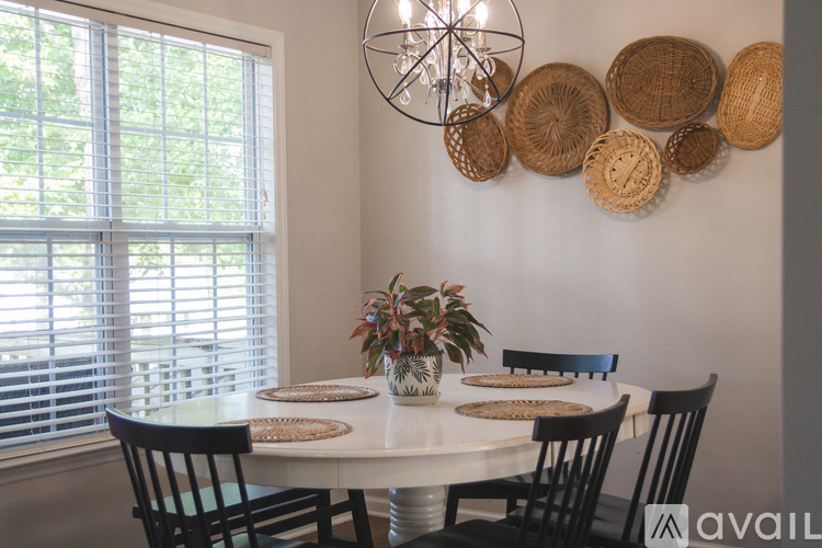 A dining room with a table set for four.