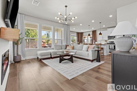 A modern living room with a white sofa set and a wooden coffee table.