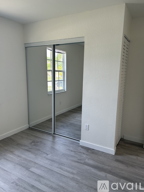 A room with a sliding door leading to a balcony.
