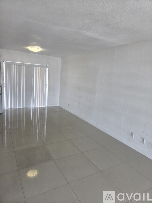 A room with white walls and a white door.