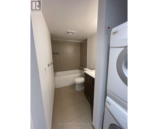 A small laundry room with a washer and dryer.