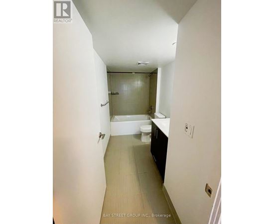 A bathroom with a toilet, sink, and bathtub.