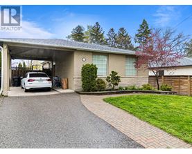 A car is parked in a driveway leading to a house.