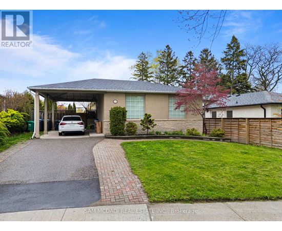 A house with a car parked in front of it.