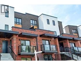A modern apartment building with balconies and multiple stories.