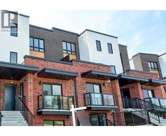 A modern apartment building with balconies and multiple stories.