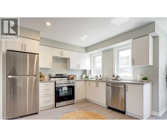 A modern kitchen with stainless steel appliances and white cabinets.