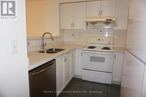A kitchen with white appliances and cabinets.