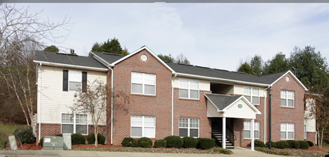A two-story brick house with a white garage door.