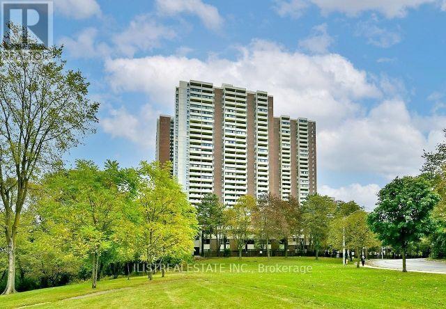 A tall building with a lawn in front of it.