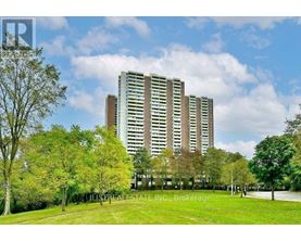 A tall building with a lawn in front of it.