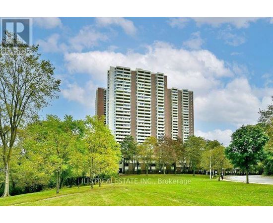 A tall building with a lawn in front of it.