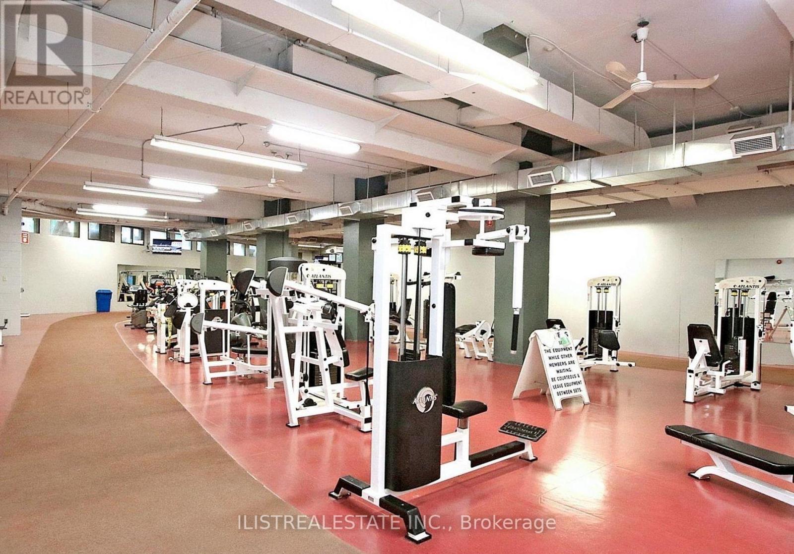 A gym with a variety of equipment including weights and cardio machines.