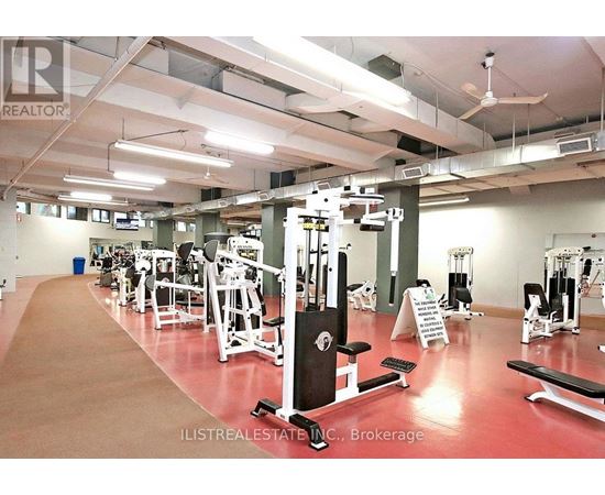 A gym with a variety of equipment including weights and cardio machines.