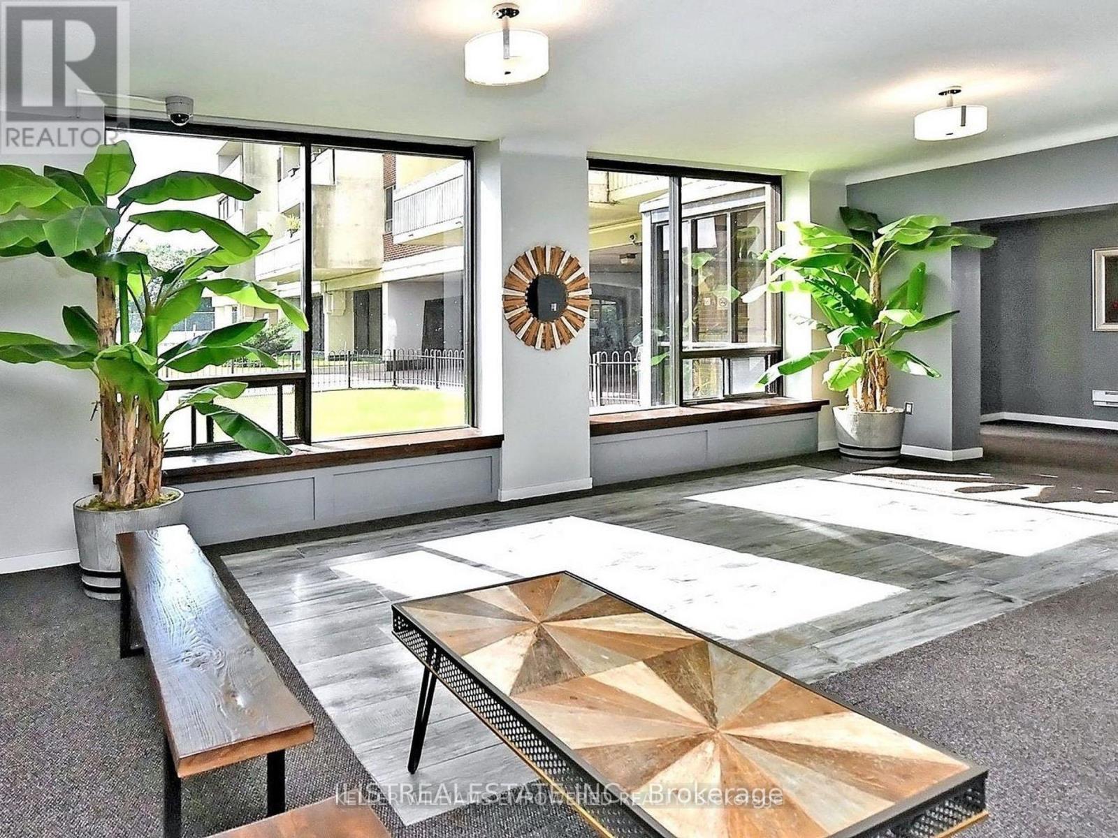 A modern living room with a wooden bench and a large coffee table.
