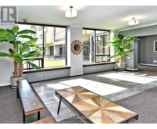A modern living room with a wooden bench and a large coffee table.