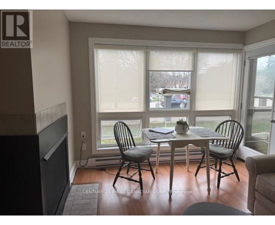 A dining room with a table and chairs.