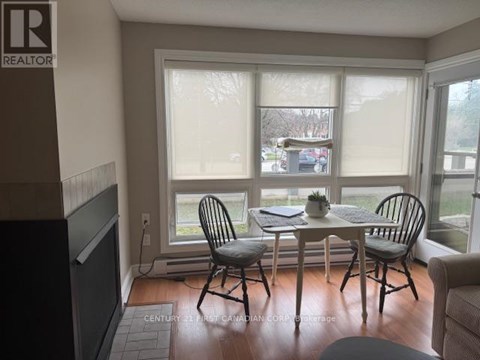 A dining room with a table and chairs.