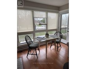 A dining room with a table and chairs.