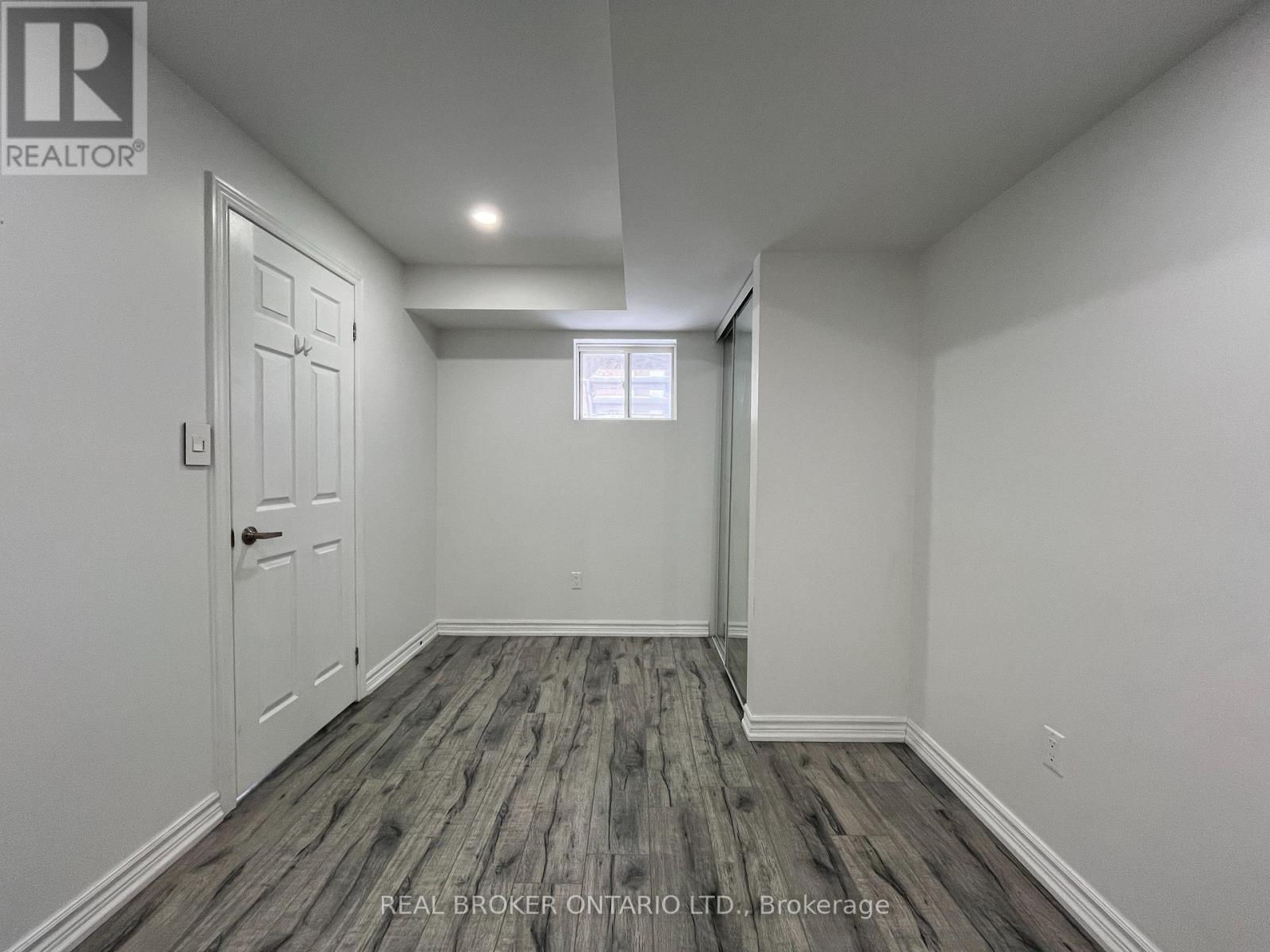 A room with a wooden floor and white walls.