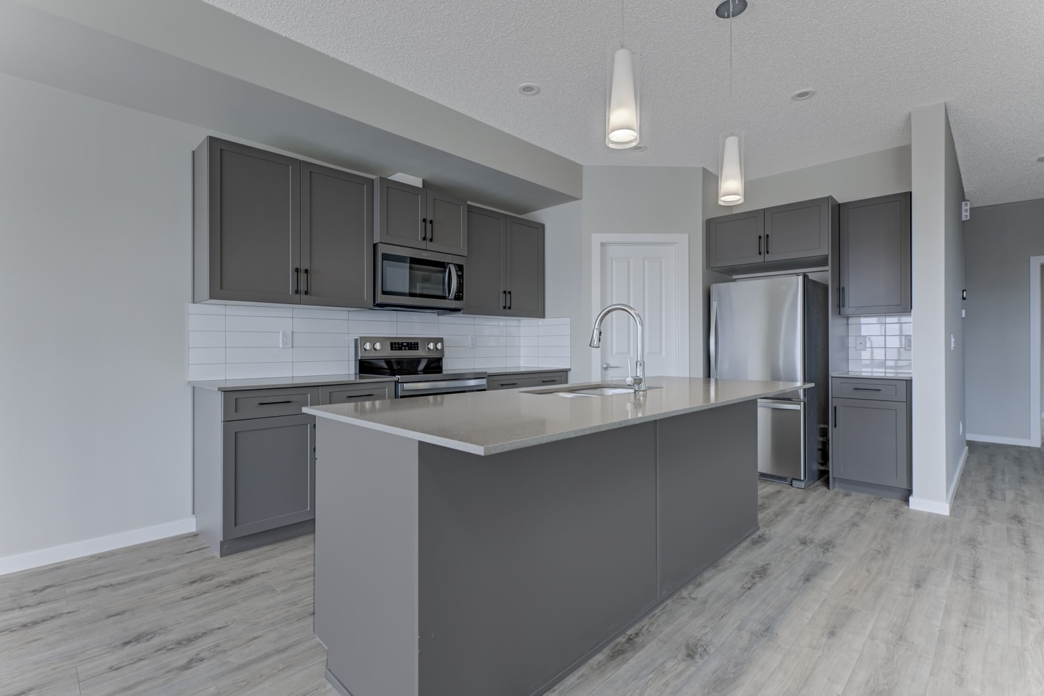 A modern kitchen with a large island in the center.