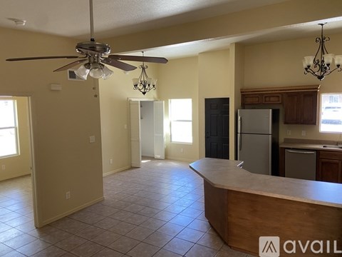 A kitchen with a fan and a counter is available for rent.