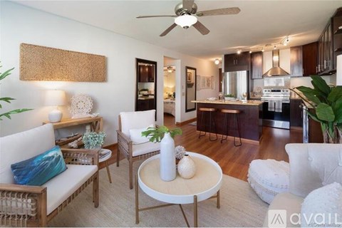 A living room with a white couch and a wooden coffee table.