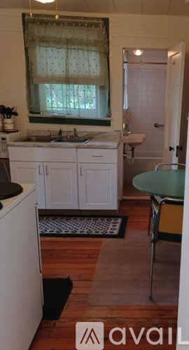 A kitchen with white cabinets and a sink.