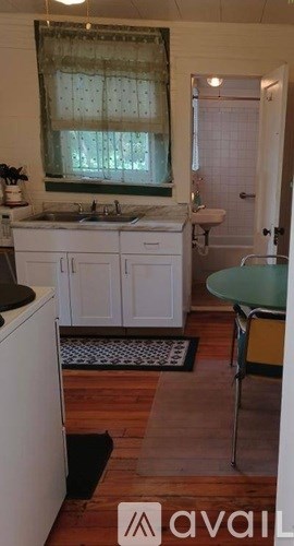 A kitchen with white cabinets and a sink.