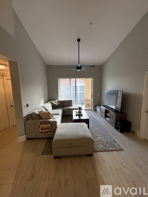 A living room with a large couch and a television.