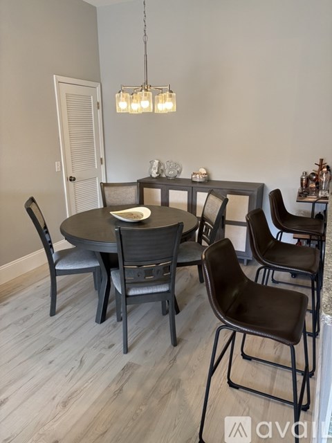 A dining room with a round table and chairs.