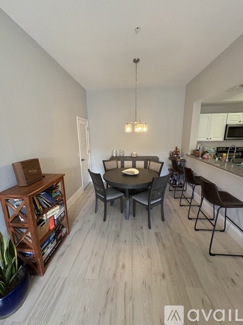 A dining area with a round table and chairs.