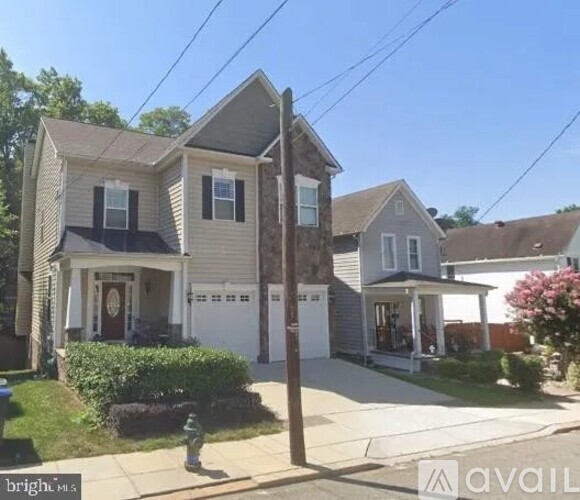A two-story house with a garage is for sale.