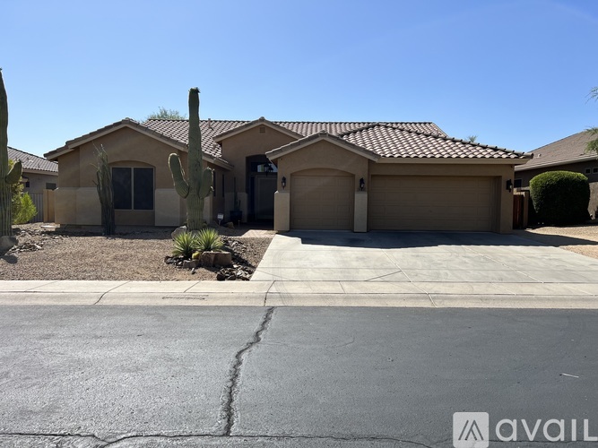 A house with a cactus in front of it.