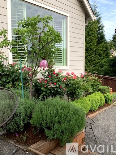 A well-maintained garden in front of a house.
