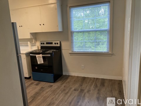 A kitchen with a stove and a window.