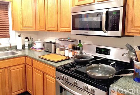 A kitchen with a stove top oven and a microwave above it.