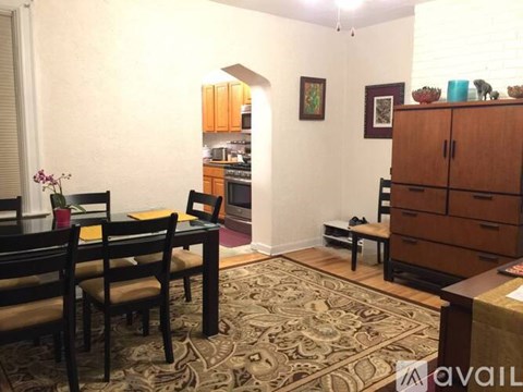 A dining room with a table set for four.