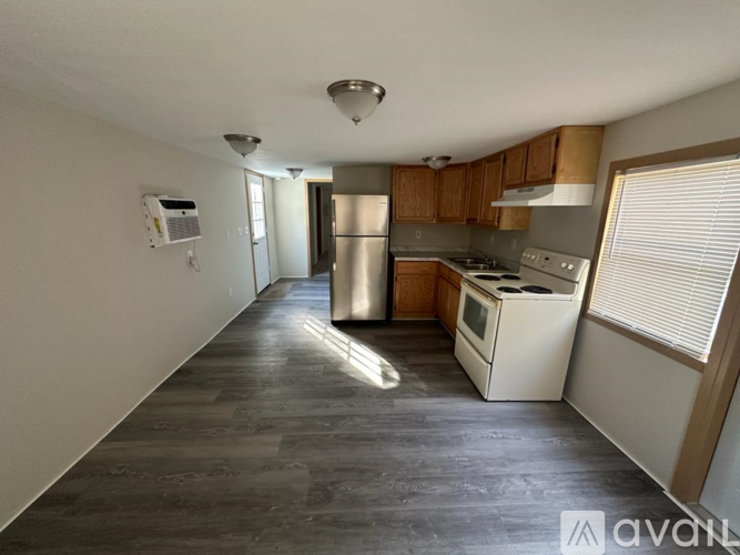 A kitchen with wooden cabinets and stainless steel appliances.