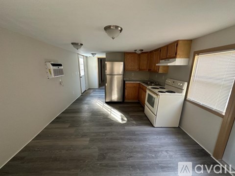 A kitchen with wooden cabinets and stainless steel appliances.