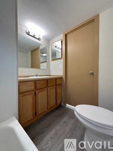 A bathroom with a tub, toilet, and sink.