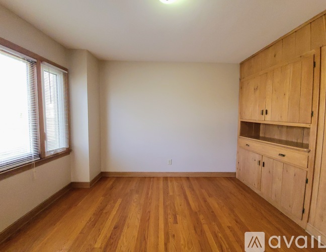 A room with wooden floors and a cabinetry unit.