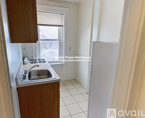A kitchen with a sink and a window.