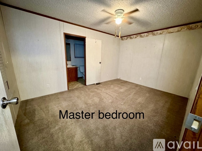 A master bedroom with a carpeted floor and a ceiling fan.