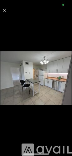 A kitchen with a table and chairs is shown.