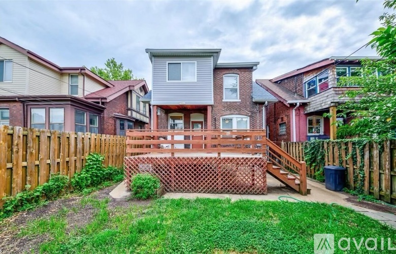 A row of houses with a green lawn in front.